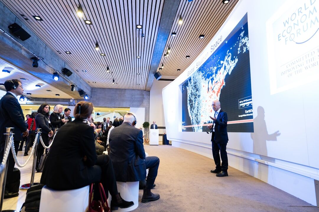 Business conference with presenter speaking on stage